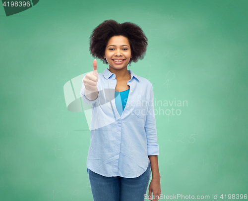 Image of happy afro american woman showing thumbs up