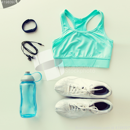 Image of sportswear, bracelet, earphones and bottle set