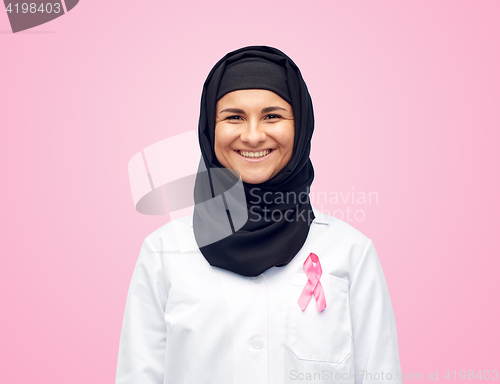 Image of muslim doctor with breast cancer awareness ribbon