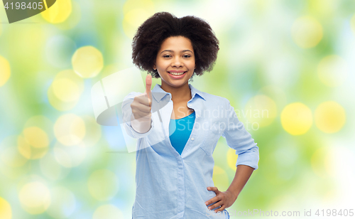 Image of happy african american woman showing thumbs up