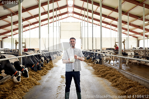 Image of man or farmer with cows milk on dairy farm