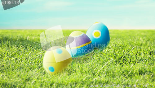 Image of close up of colored easter eggs on grass