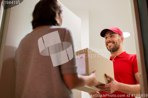 Image of happy delivery man giving parcel box to customer