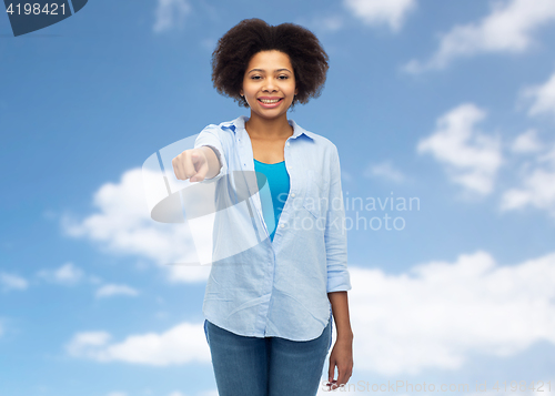 Image of happy african woman pointing finger to you