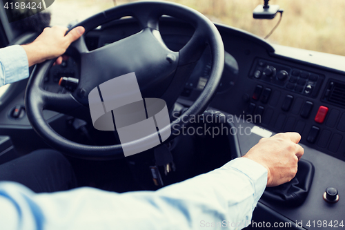 Image of close up of driver driving passenger bus