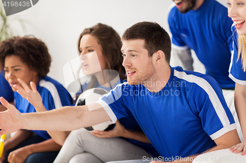 Image of friends or football fans watching soccer at home