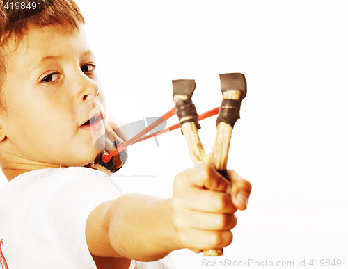 Image of little cute angry real boy with slingshot isolated