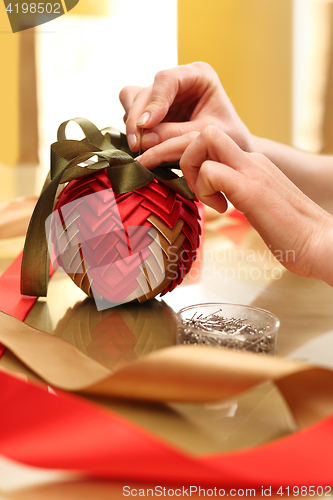 Image of Holy Christmas, a woman carries a beautiful home decorations