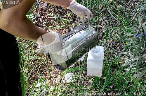 Image of Take samples of water for laboratory testing. The concept - analysis of water purity, environment, ecology.