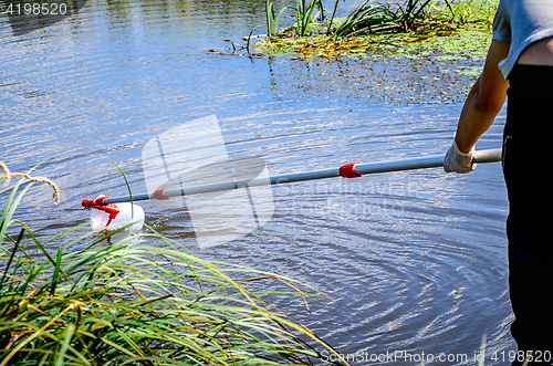 Image of Take samples of water for laboratory testing. The concept - analysis of water purity, environment, ecology.