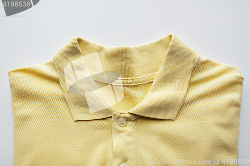 Image of close up of polo t-shirt on white background