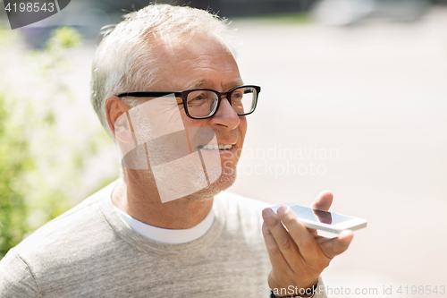 Image of old man using voice command recorder on smartphone