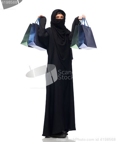 Image of muslim woman in hijab with shopping bags