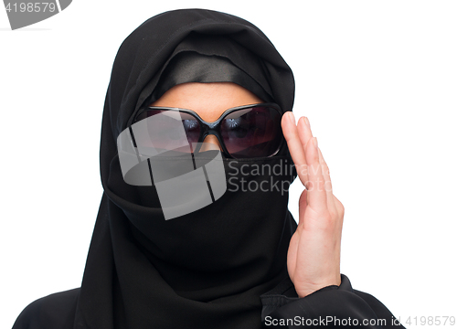 Image of muslim woman in hijab and sunglasses over white