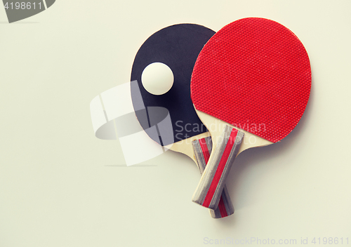 Image of close up of table tennis rackets with ball