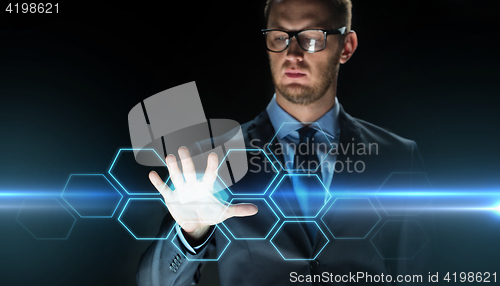 Image of businessman touching virtual hexagonal projection