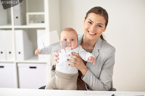 Image of happy businesswoman with baby at office