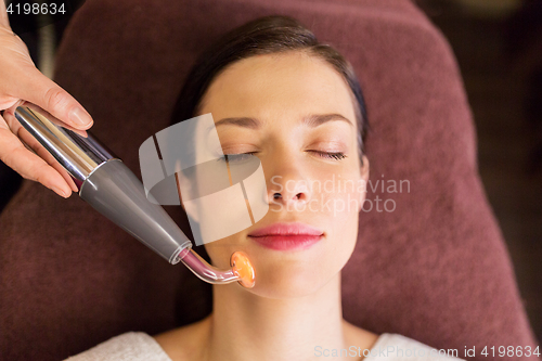 Image of woman having hydradermie facial treatment in spa