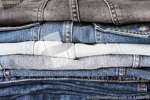 Image of close up of denim clothes or jeans pile