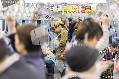 Image of Crowd of people commuting daily on Tokyo metro.