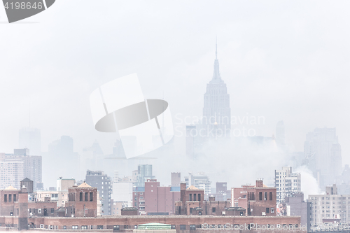 Image of Misty New York City Manhattan skyline with Empire State Building.