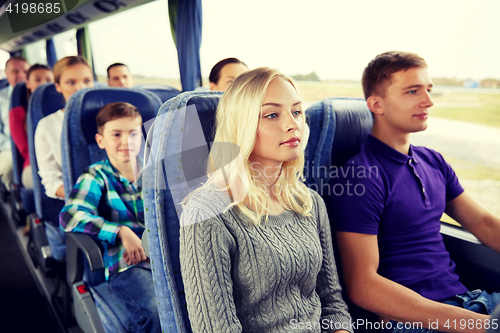 Image of happy couple or passengers in travel bus