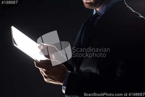 Image of close up of businessman with transparent tablet pc