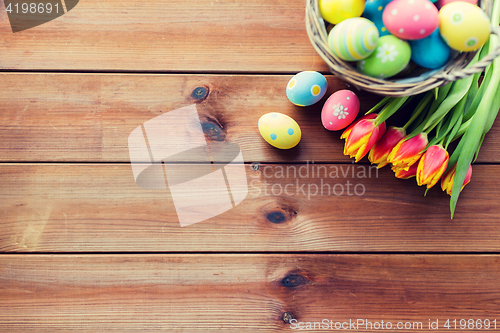 Image of close up of easter eggs in basket and flowers