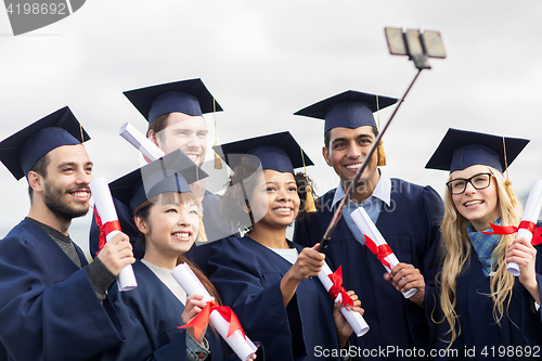 Image of students or bachelors taking selfie by smartphone