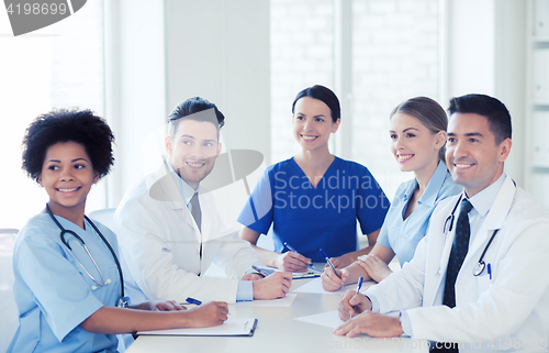 Image of group of happy doctors meeting at hospital office