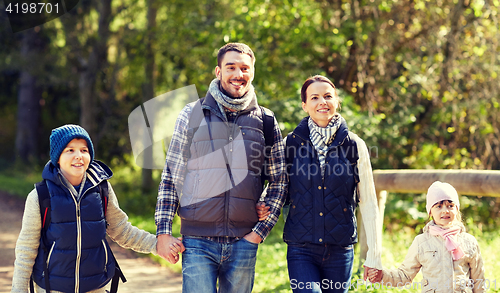 Image of happy family with backpacks hiking