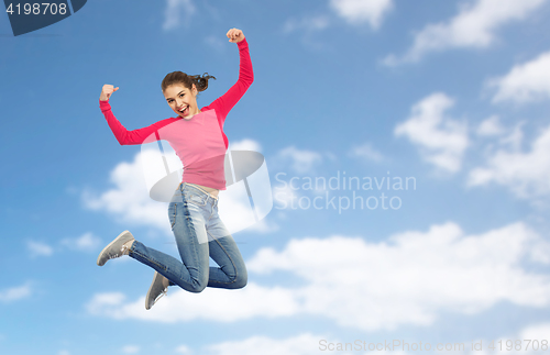 Image of smiling young woman jumping in air