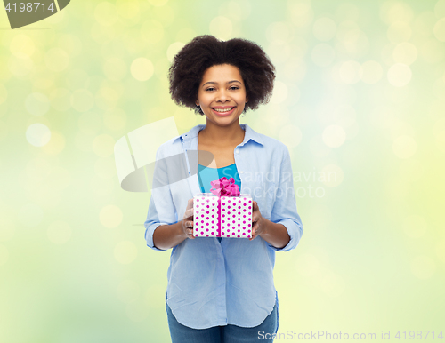 Image of happy african woman with birthday gift box