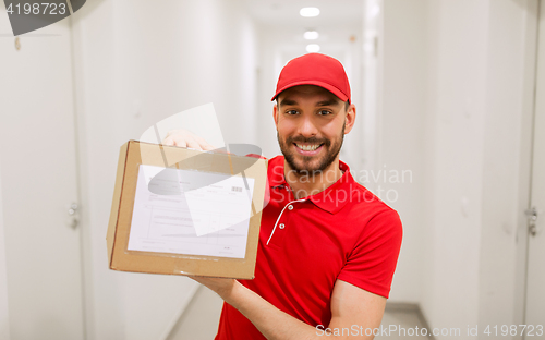 Image of delivery man with parcel box in corridor