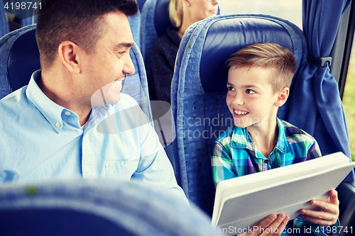 Image of happy family with tablet pc sitting in travel bus