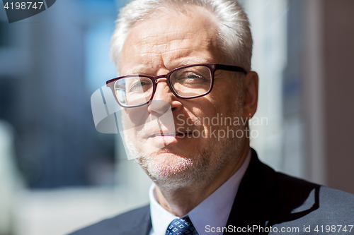 Image of close up of senior businessman in eyeglasses