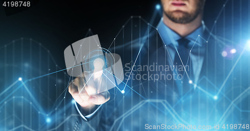 Image of businessman touching virtual charts projection