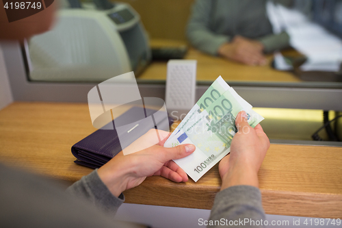 Image of hands with money at bank or currency exchanger