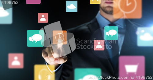 Image of close up of businessman touching virtual icons