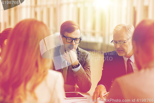 Image of architects with tablet pc and blueprint at office