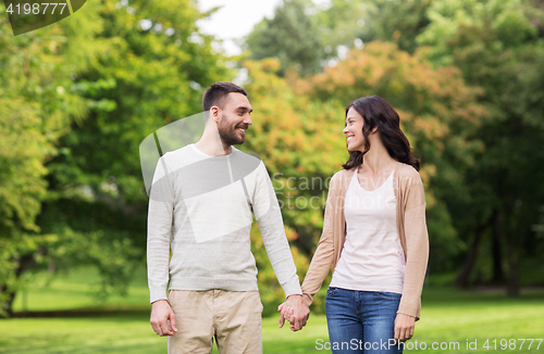 Image of happy couple dating in summer park