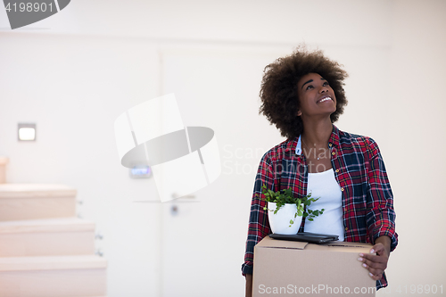 Image of Black girl moving in the new apartment