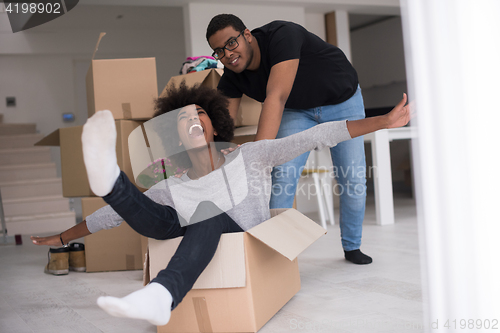 Image of African American couple  playing with packing material