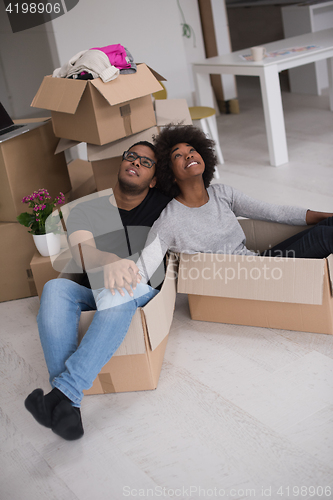 Image of African American couple  playing with packing material