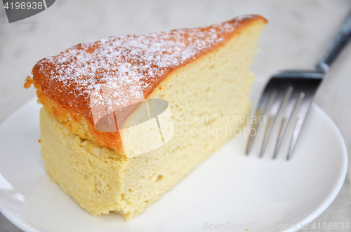 Image of Yellow cheese cake on table 