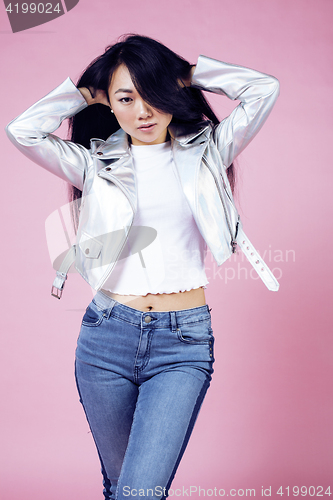 Image of young pretty smiling asian korean girl wearing modern fashion clothers on pink background, lifestyle people concept 