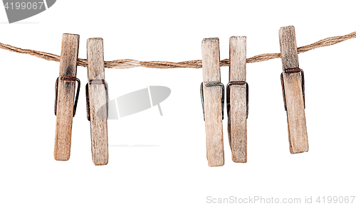 Image of Five old clothespins on rope