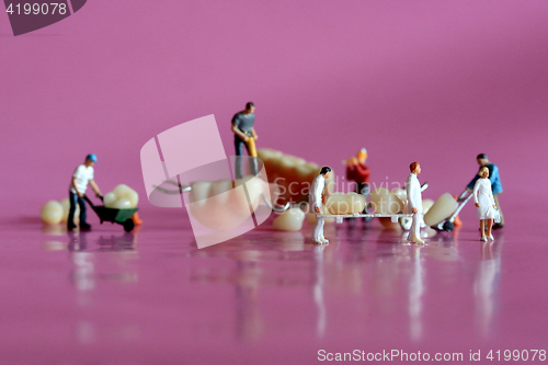 Image of Miniature Workers Performing Dental Procedures. Dental Office Ar