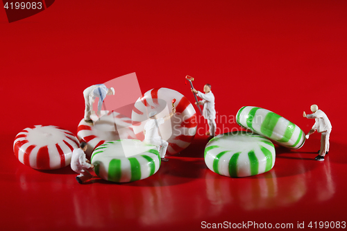 Image of Miniature People Who Paint Colors on Our Candy