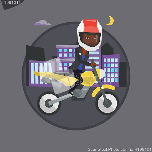 Image of Woman riding motorcycle at night.